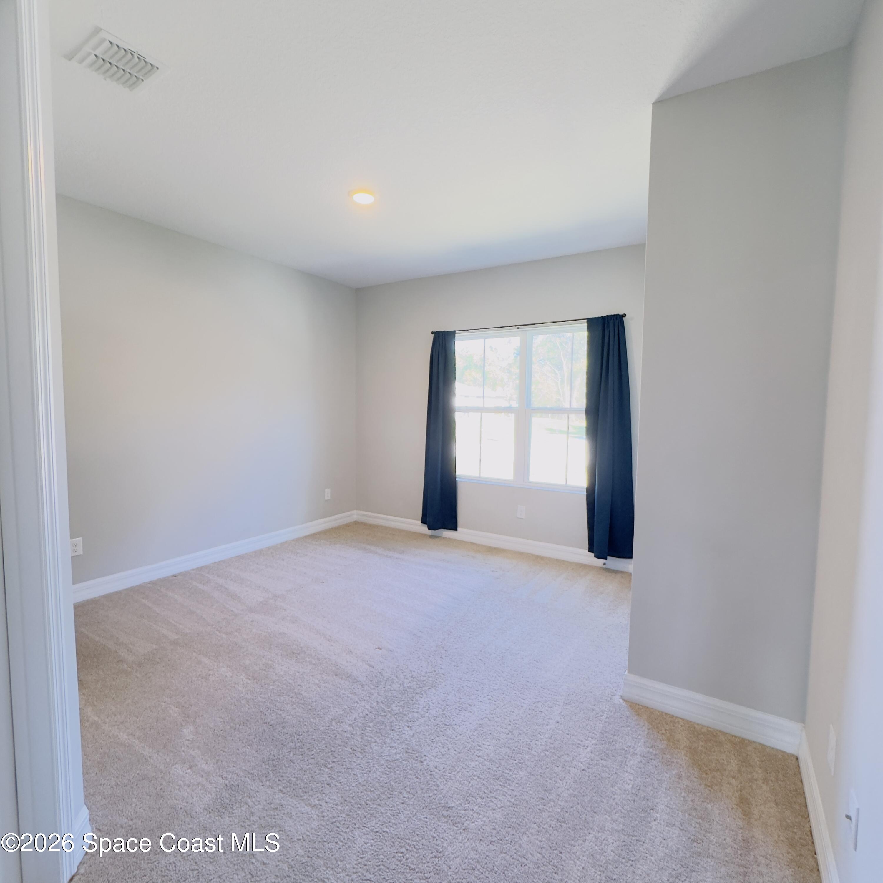 1376 Torgerson Road Southeast Palm Bay, FL 32909 - Photo 7 of 15 a view of an empty room with a window