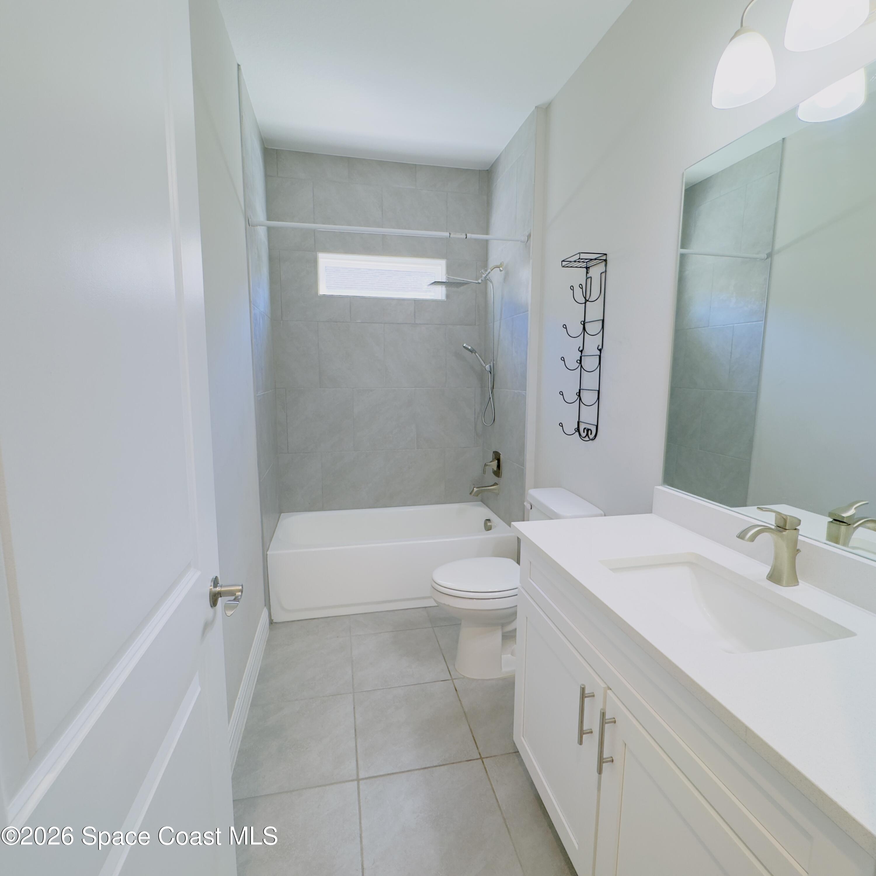 1376 Torgerson Road Southeast Palm Bay, FL 32909 - Photo 10 of 15 a bathroom with a sink a toilet and shower