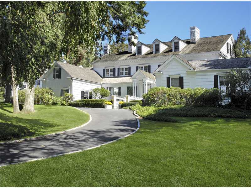 22 Perkins Road Greenwich, CT 06830 - Photo 1 of 16 a front view of a house with a garden and plants