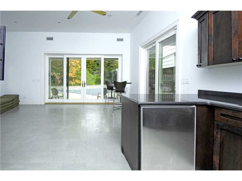 22 Perkins Road Greenwich, CT 06830 - Photo 13 of 16 a open kitchen with granite countertop a stove a sink a window and a dining table