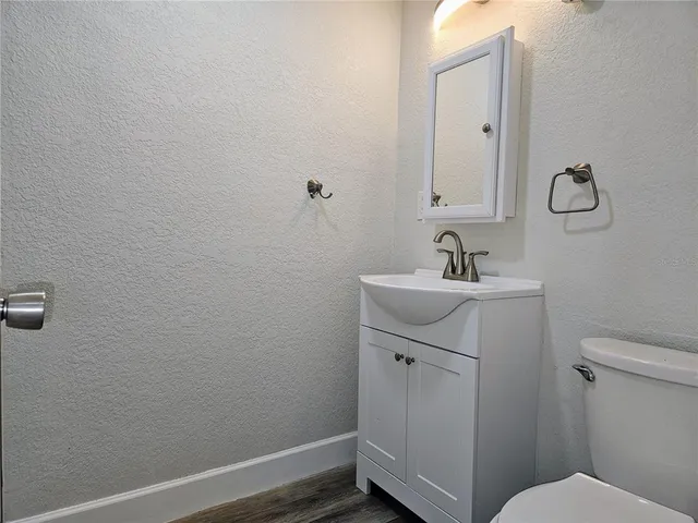 a bathroom with a sink toilet and vanity
