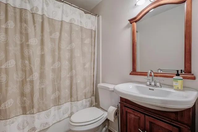 a bathroom with a sink toilet and shower