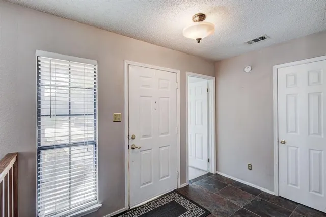 a view of a room with an entryway and wooden floor