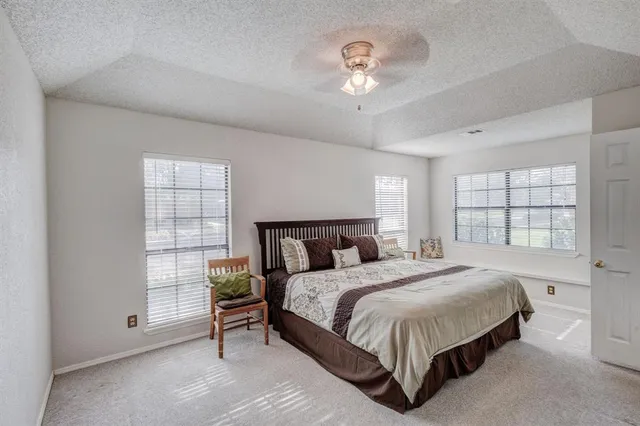 a large bed sitting in a room next to a window