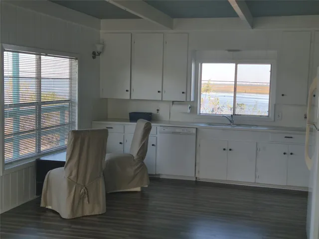 a view of cabinets chair and wooden floor