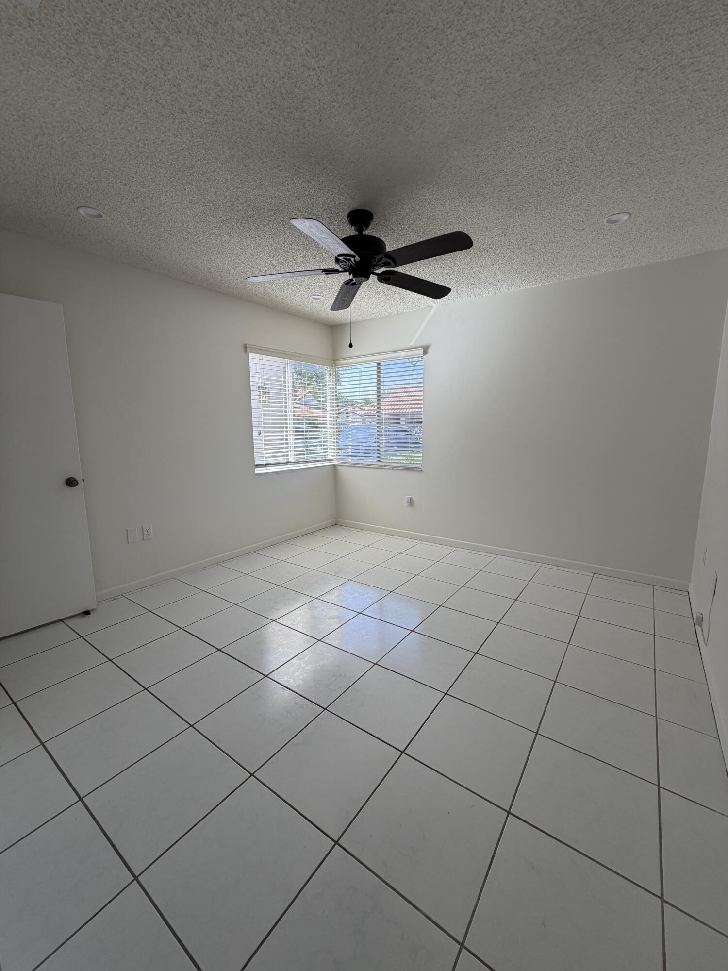 6356 Pointe Pleasant Circle, Unit G Delray Beach, FL 33484 - Photo 11 of 31 a view of an empty room and window