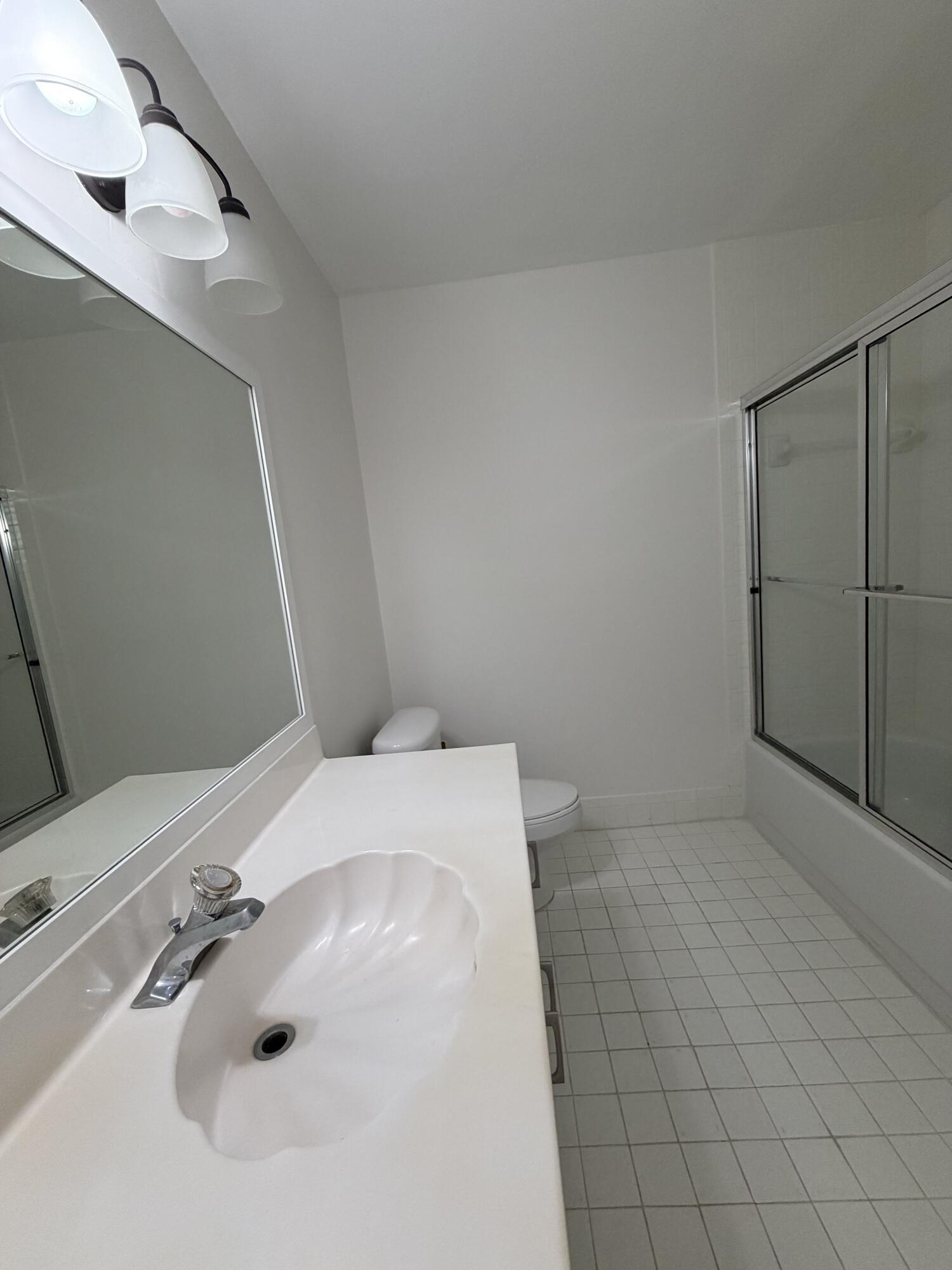 6356 Pointe Pleasant Circle, Unit G Delray Beach, FL 33484 - Photo 12 of 31 a bathroom with a sink and vanity
