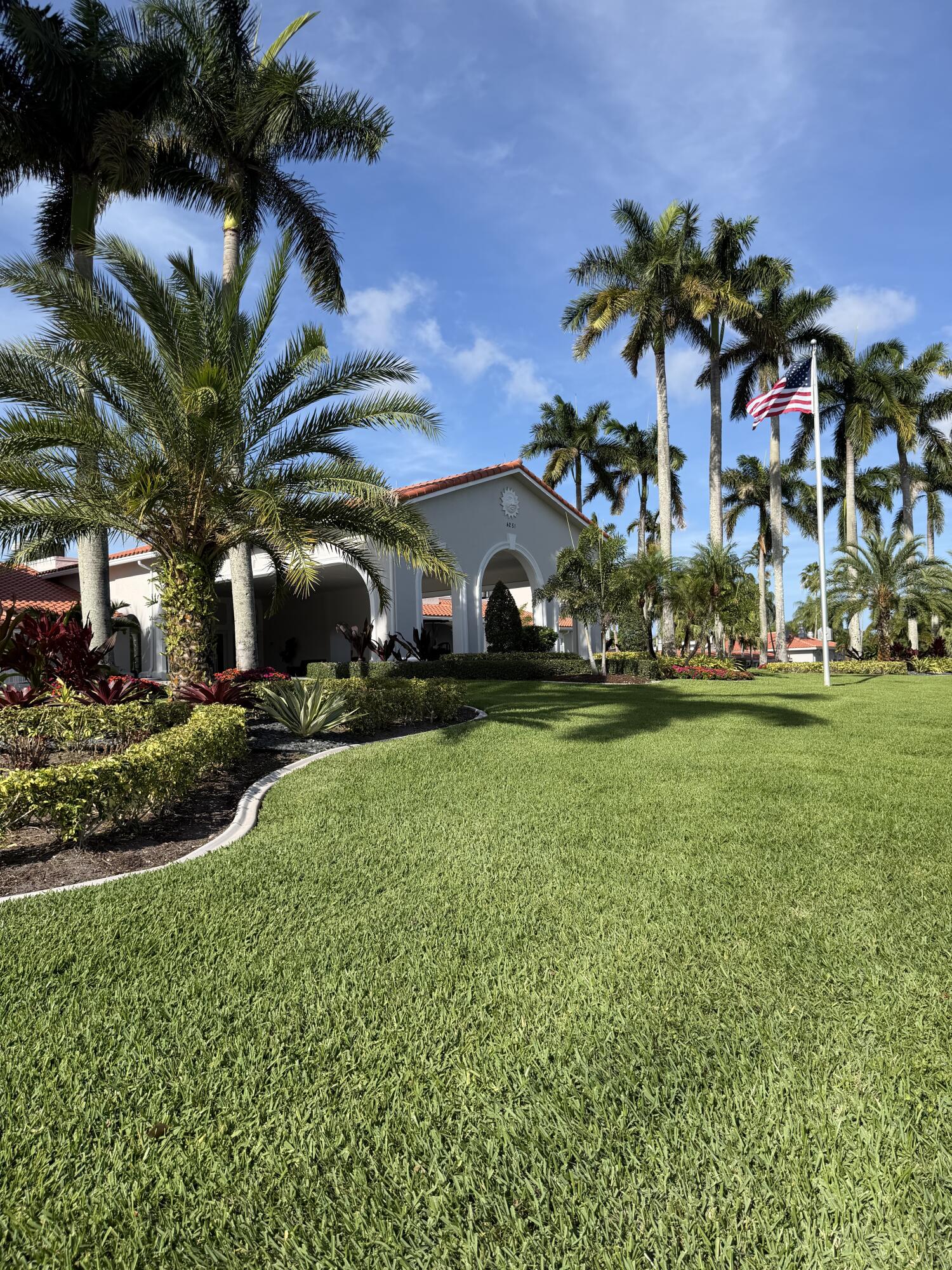 6356 Pointe Pleasant Circle, Unit G Delray Beach, FL 33484 - Photo 19 of 31 a view of a house with a big yard and palm trees