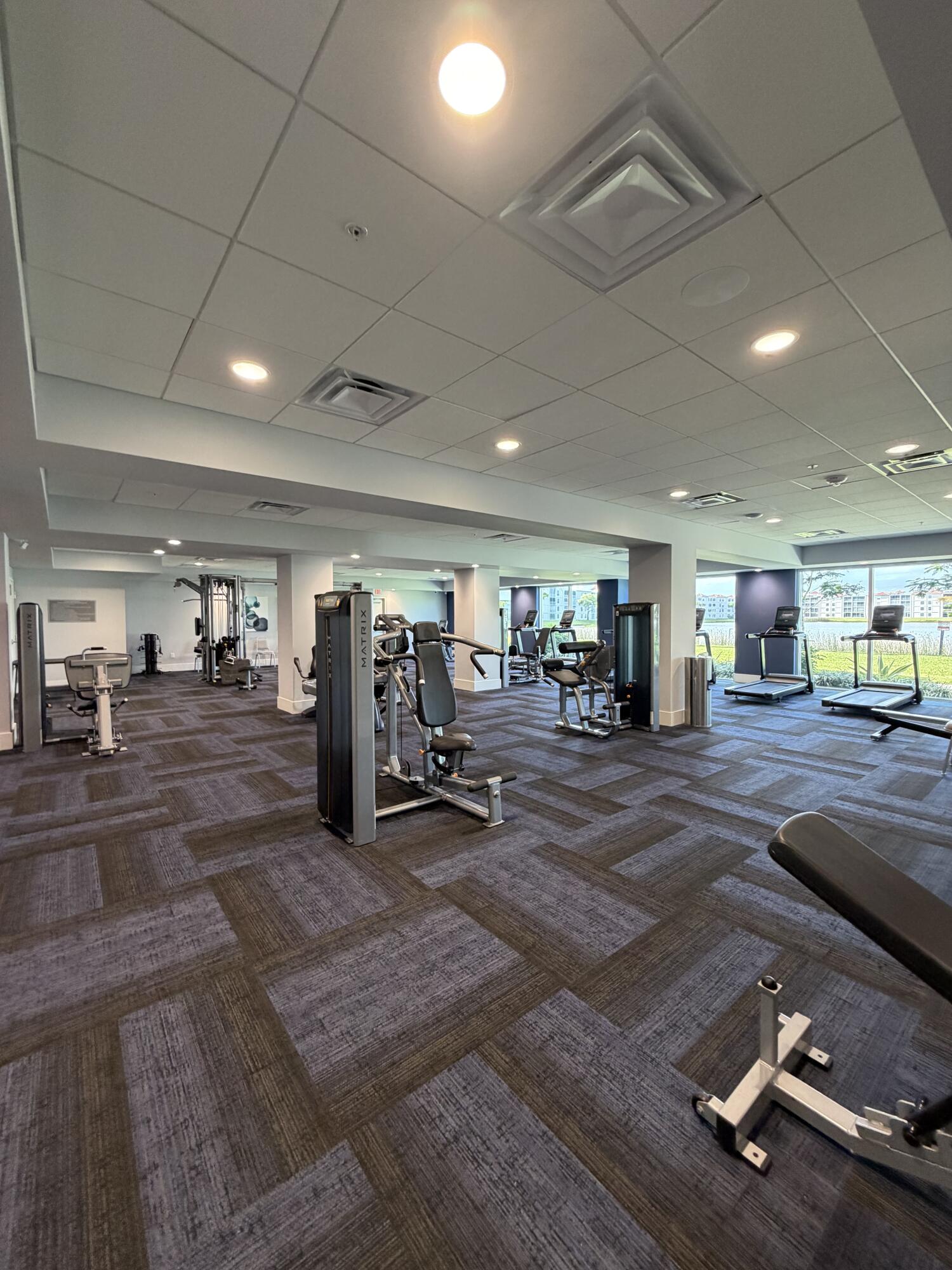 6356 Pointe Pleasant Circle, Unit G Delray Beach, FL 33484 - Photo 26 of 31 a view of a room with gym equipment