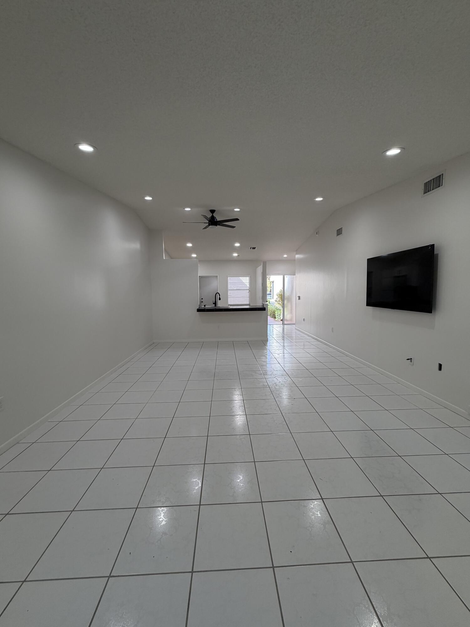 6356 Pointe Pleasant Circle, Unit G Delray Beach, FL 33484 - Photo 5 of 31 a view of an empty room with wooden floor