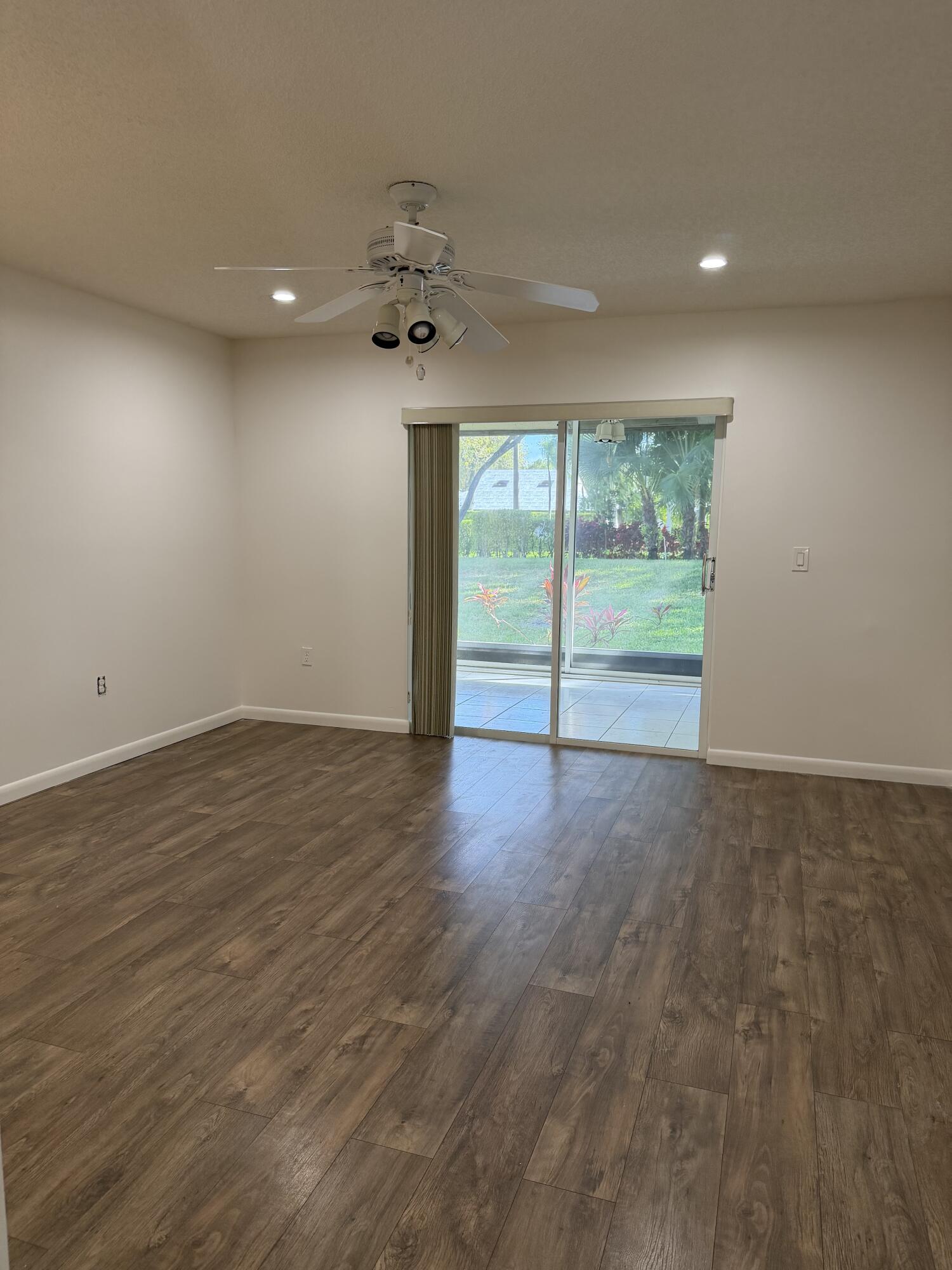6356 Pointe Pleasant Circle, Unit G Delray Beach, FL 33484 - Photo 9 of 31 an empty room with wooden floor and windows