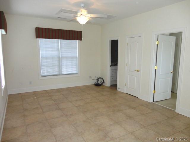 121 South Faulkner Way Davidson, NC 28036 - Photo 3 of 10 an empty room with windows and fan