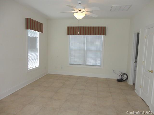 121 South Faulkner Way Davidson, NC 28036 - Photo 4 of 10 an empty room with windows and fan