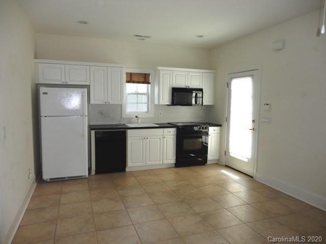 121 South Faulkner Way Davidson, NC 28036 - Photo 5 of 10 a kitchen with stainless steel appliances granite countertop a sink counter space and cabinets