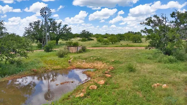 a view of a patio with a table and chairs under an umbrella