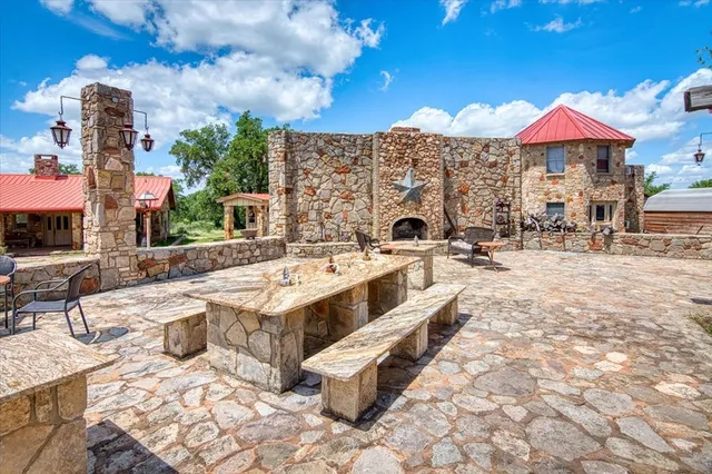 a view of a patio with table and chairs