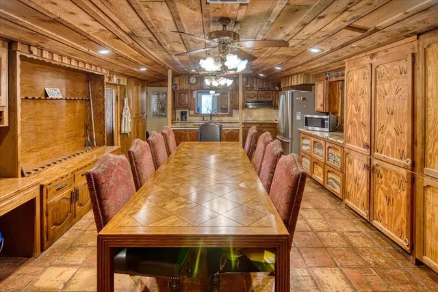 a kitchen with stainless steel appliances granite countertop a stove and a wooden cabinets