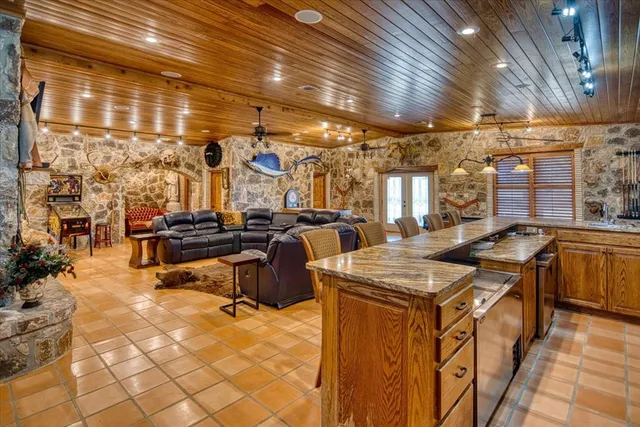 a kitchen with stainless steel appliances granite countertop a stove a sink and a refrigerator