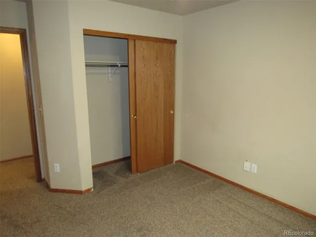 an empty room with closet area