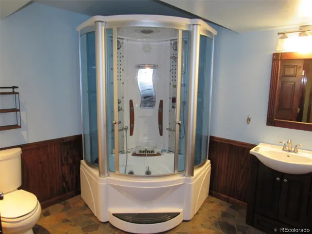 a bathroom with a toilet a sink and bathtub