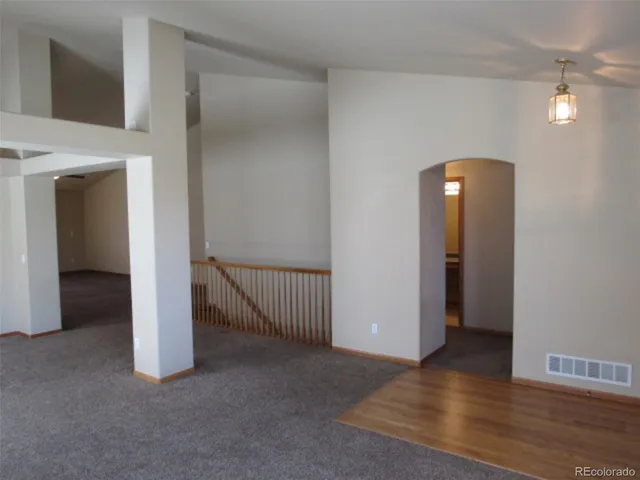 a view of a room with wooden floor and stairs