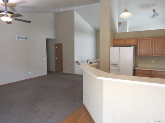 a room with a window and refrigerator