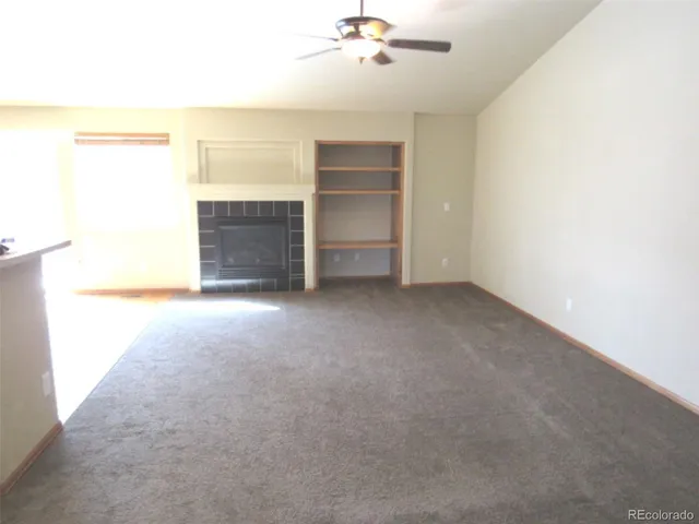 a view of an empty room with a ceiling fan