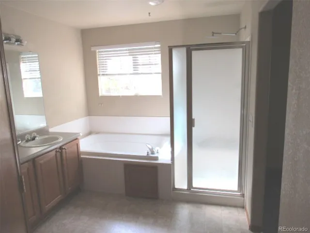 a bathroom with a bathtub sink and mirror