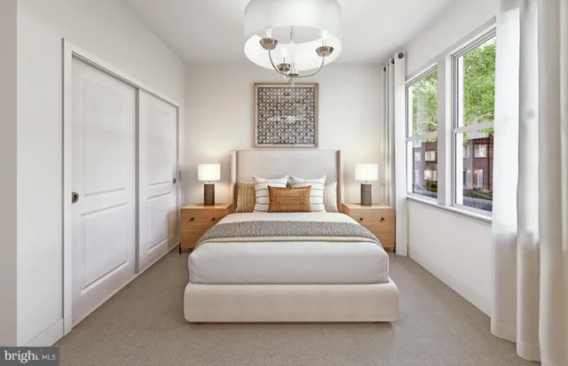 a spacious bedroom with a bed and a window