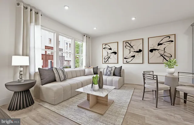 a living room with furniture and large window with rug