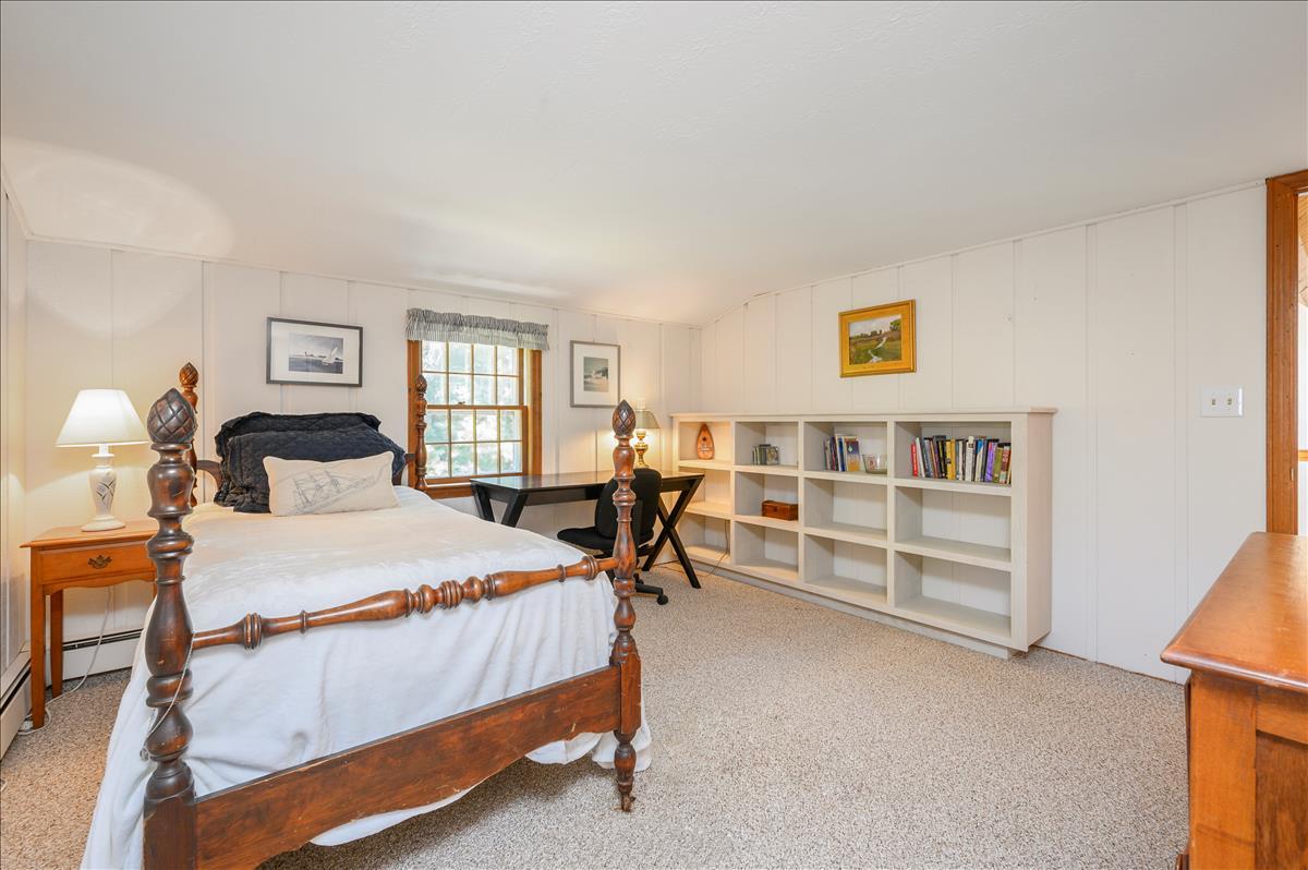 218 Hickory Hill Circle Osterville, MA 02655 - Photo 19 of 30 a bedroom with a bed and a bookshelf
