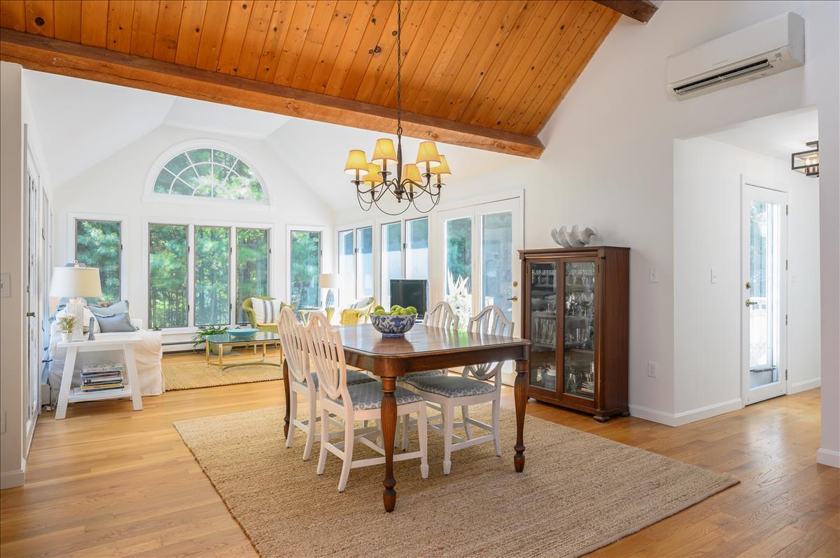 218 Hickory Hill Circle Osterville, MA 02655 - Photo 4 of 30 a dining room with furniture large windows and a chandelier
