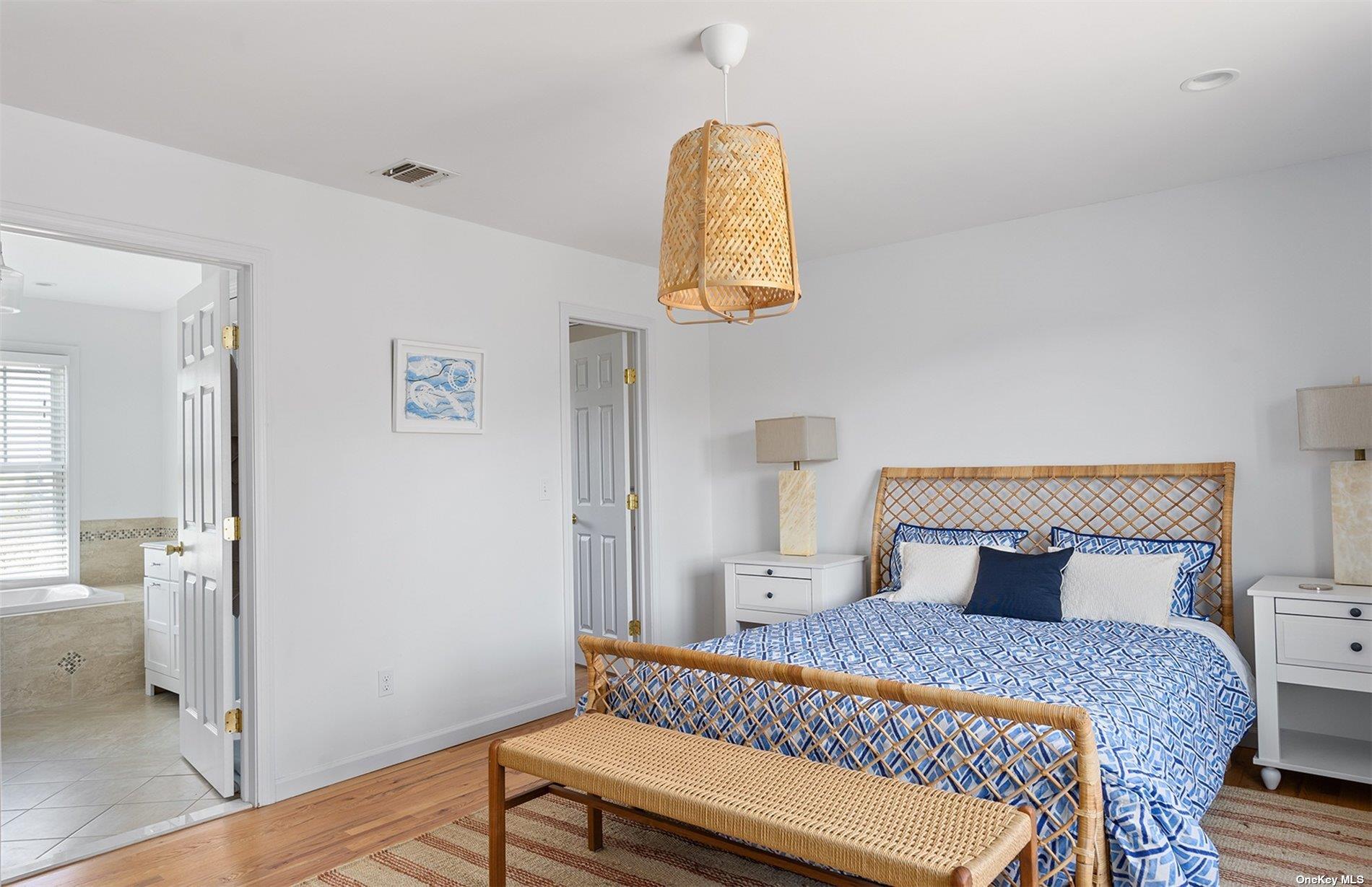 355 Midway Road Southold, NY 11971 - Photo 13 of 24 a bedroom with a bed and wooden floor