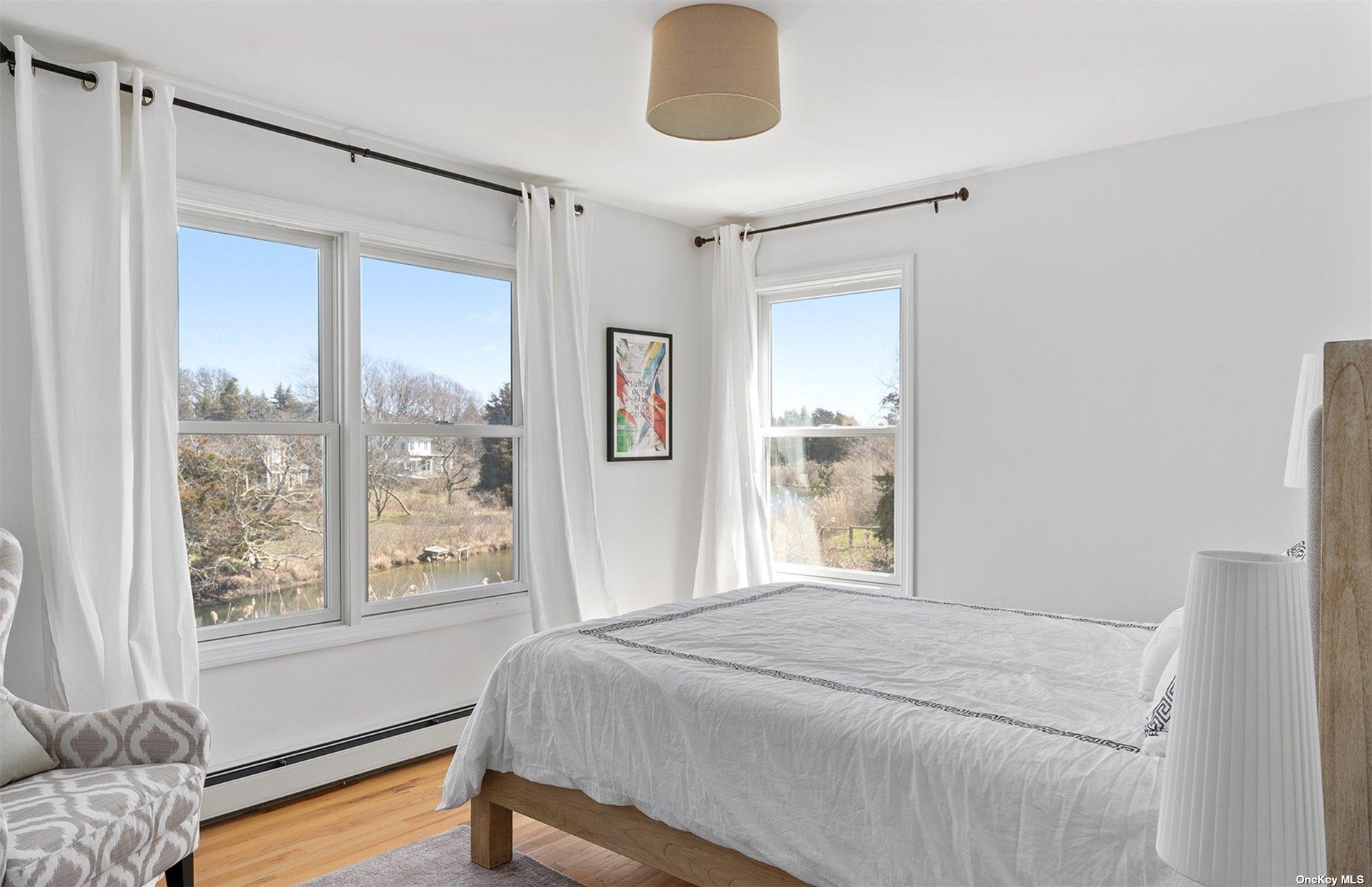 355 Midway Road Southold, NY 11971 - Photo 15 of 24 a bedroom with a bed mirror and window
