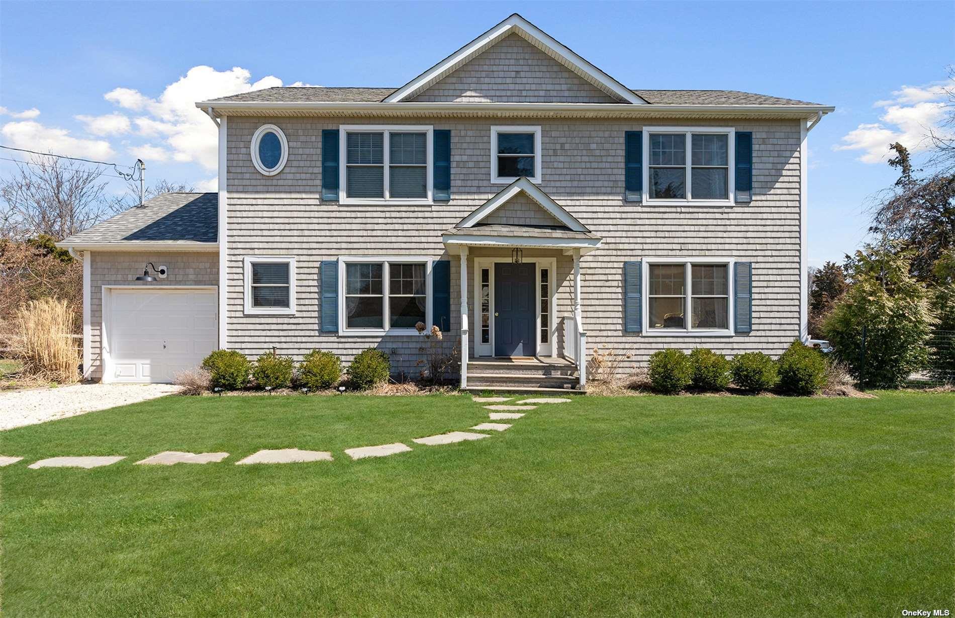 355 Midway Road Southold, NY 11971 - Photo 3 of 24 a front view of a house with a yard