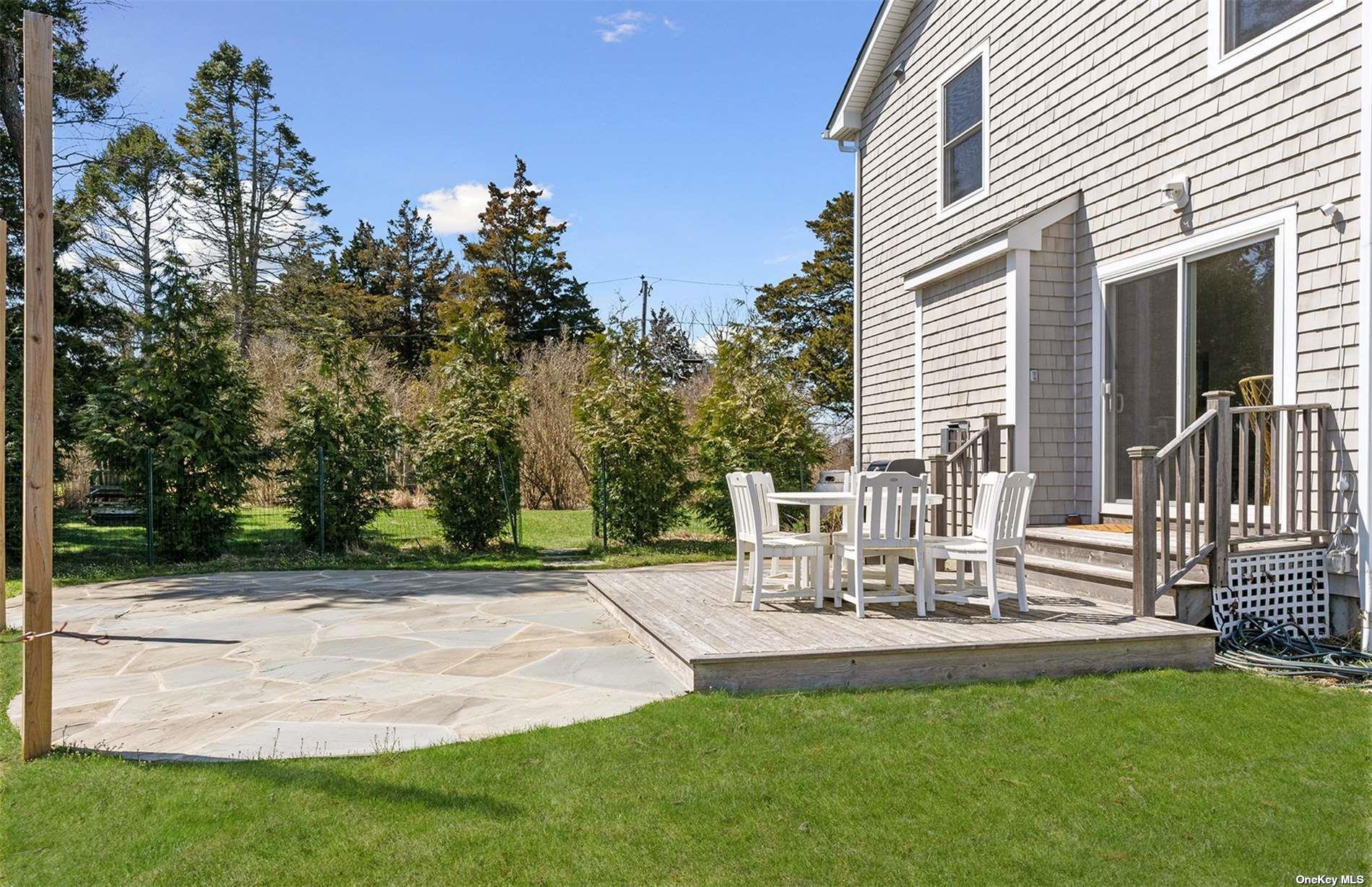 355 Midway Road Southold, NY 11971 - Photo 3 of 24 a view of patio with table and chairs and potted plants