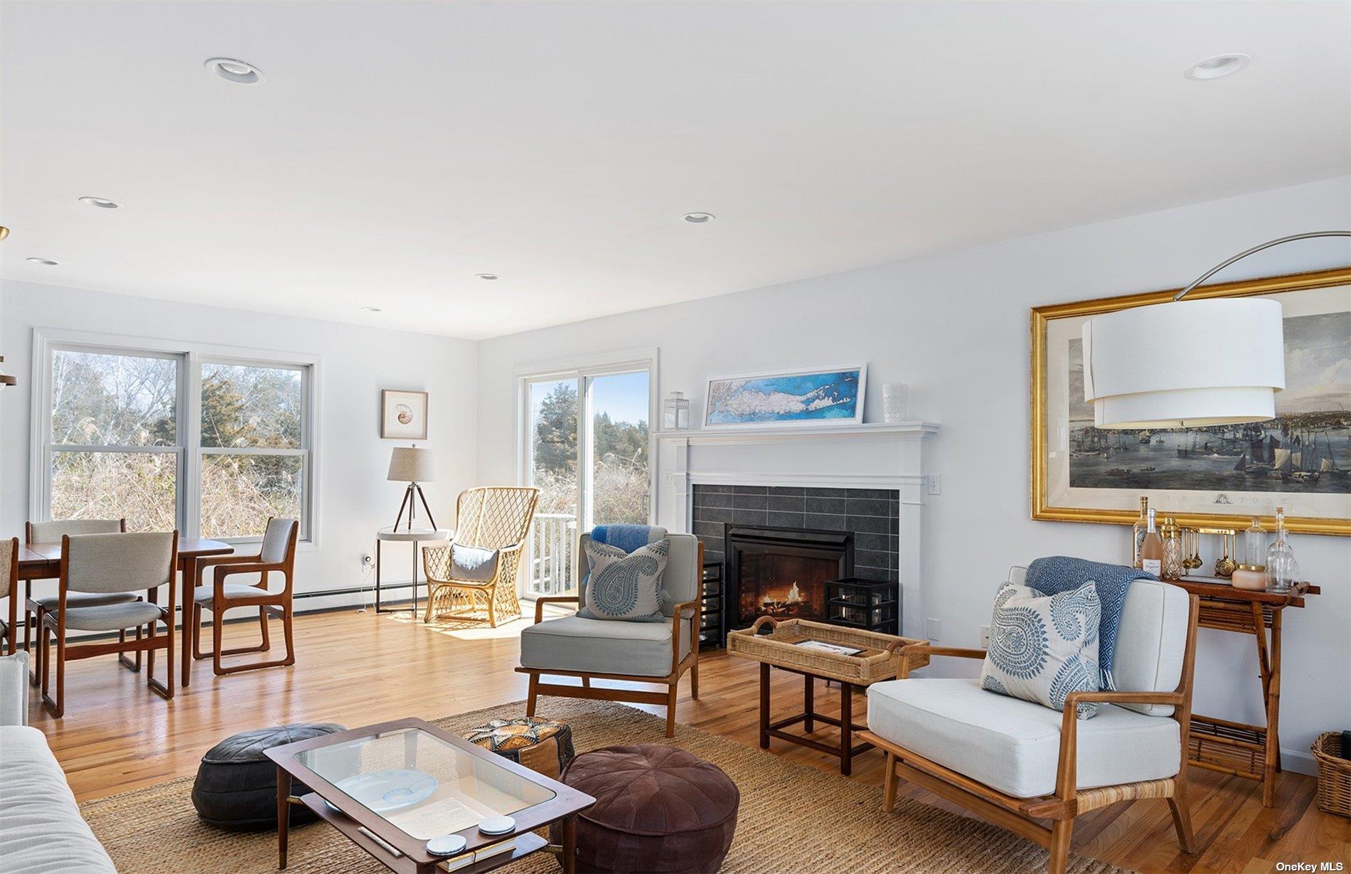 355 Midway Road Southold, NY 11971 - Photo 5 of 24 a living room with furniture a fireplace and a large window