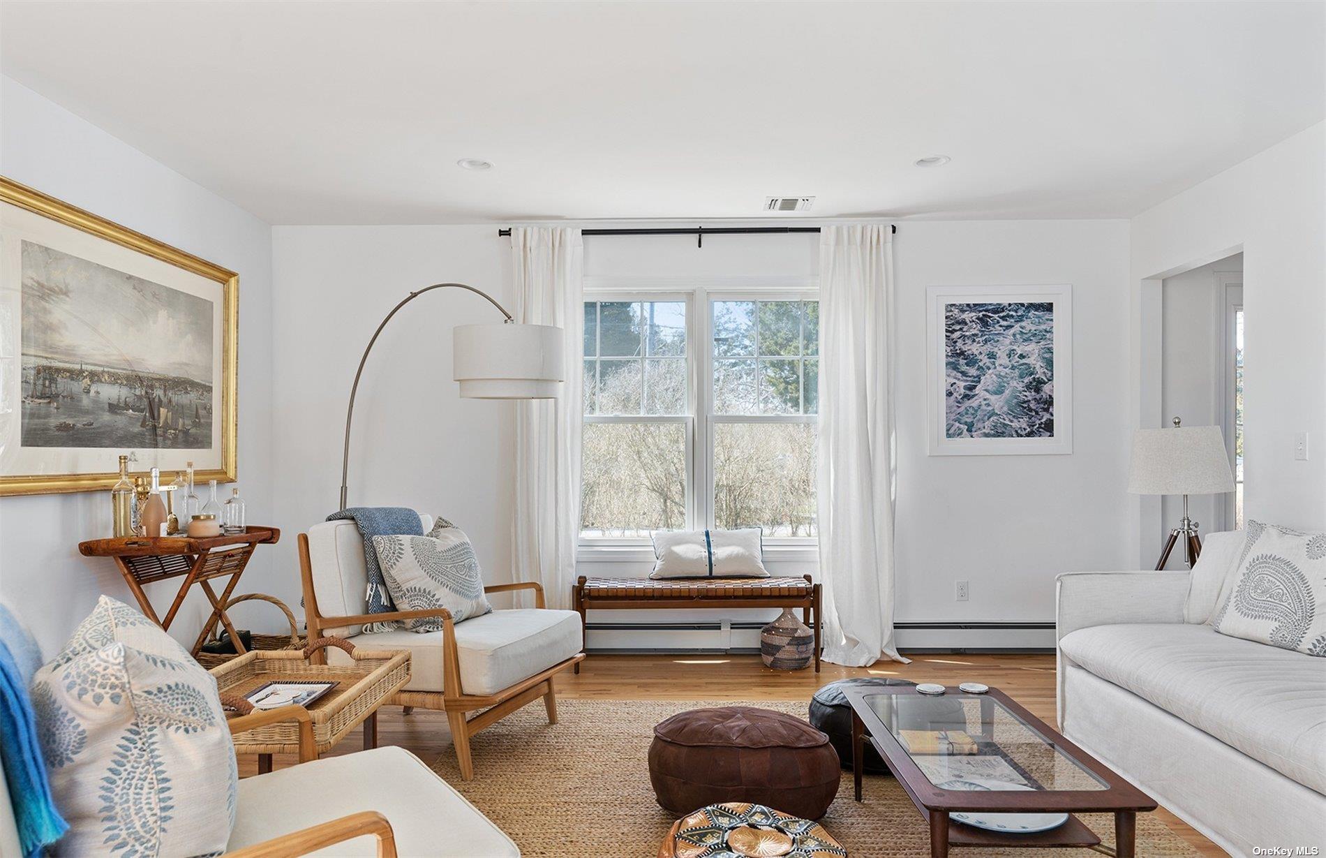 355 Midway Road Southold, NY 11971 - Photo 6 of 24 a living room with furniture and a large window