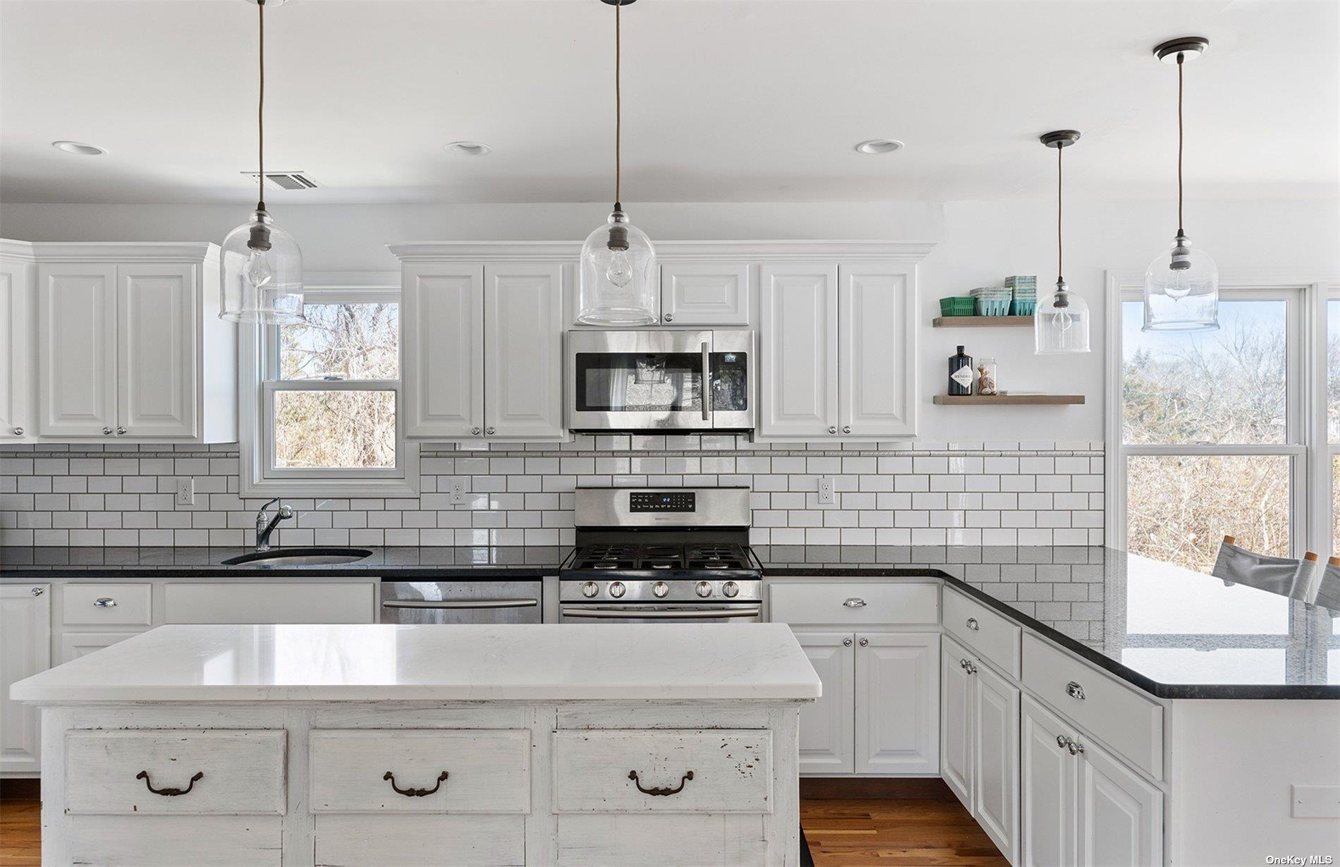 355 Midway Road Southold, NY 11971 - Photo 8 of 24 a kitchen with stainless steel appliances granite countertop a sink a stove and a granite counter tops