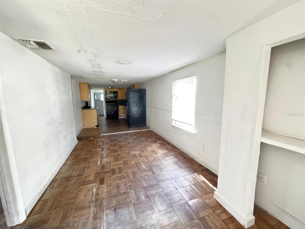 224 10th Avenue Ocoee, FL 34761 - Photo 7 of 14 a view of a hallway with wooden floor and a window