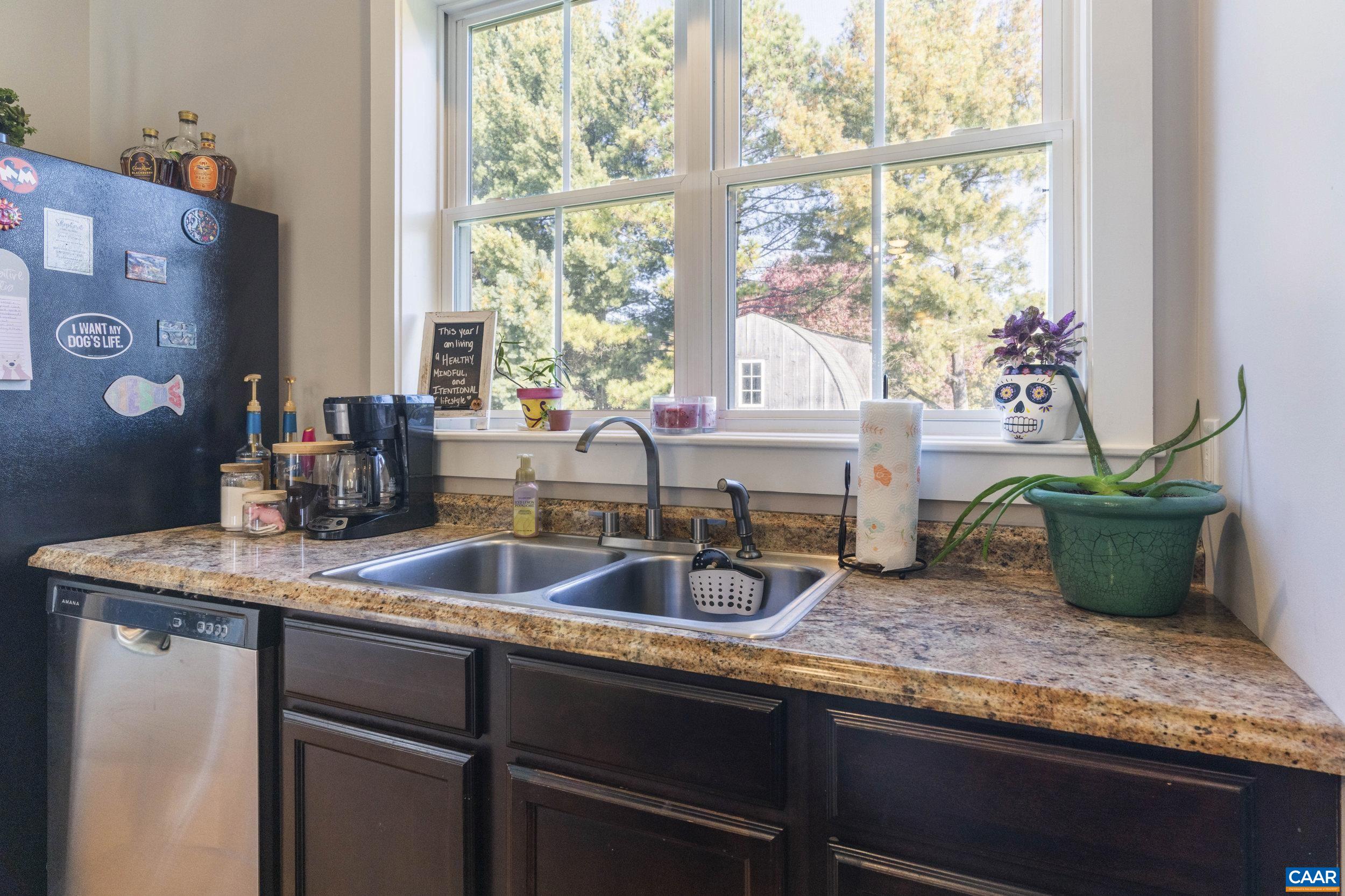 379 Crestview Drive Rustburg, VA 24588 - Photo 11 of 53 a kitchen with sink a window and potted plant