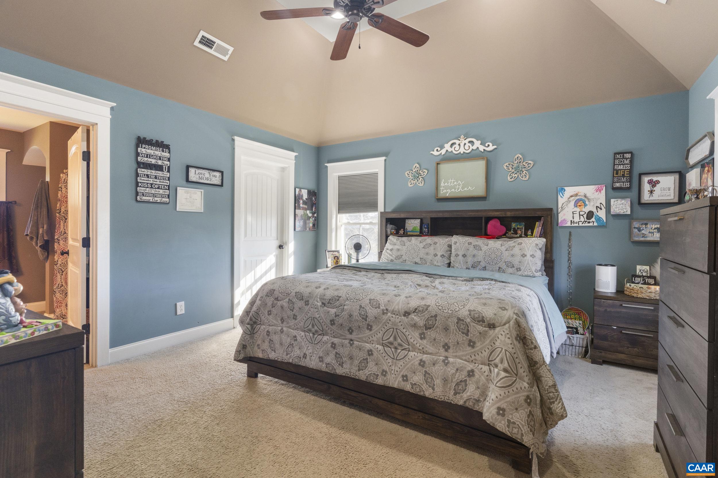379 Crestview Drive Rustburg, VA 24588 - Photo 23 of 53 a bedroom with a bed and a chandelier