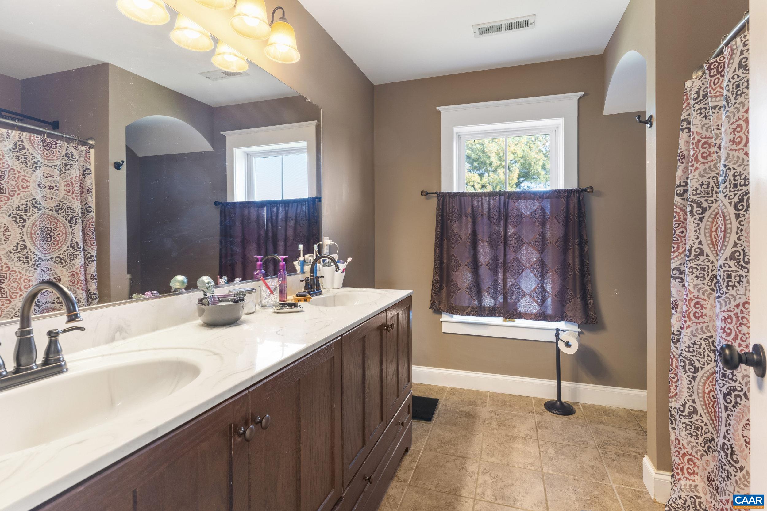 379 Crestview Drive Rustburg, VA 24588 - Photo 25 of 53 a bathroom with a sink double vanity and a mirror