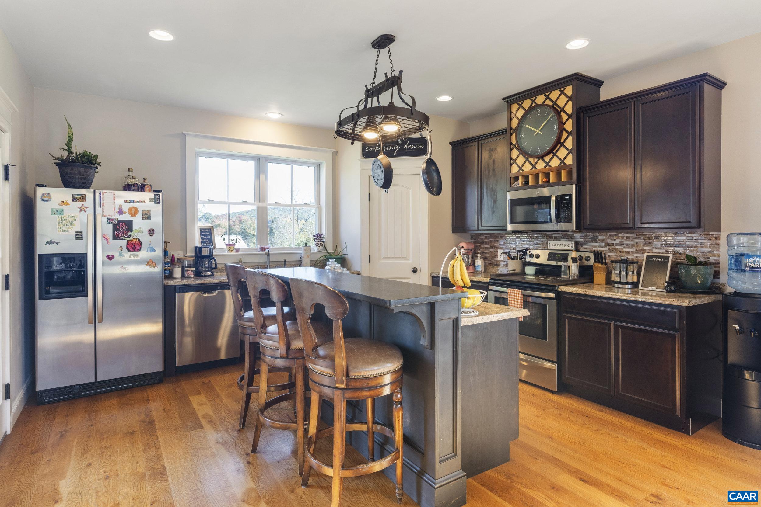 379 Crestview Drive Rustburg, VA 24588 - Photo 8 of 53 a kitchen with stainless steel appliances granite countertop a stove refrigerator and a view of living room