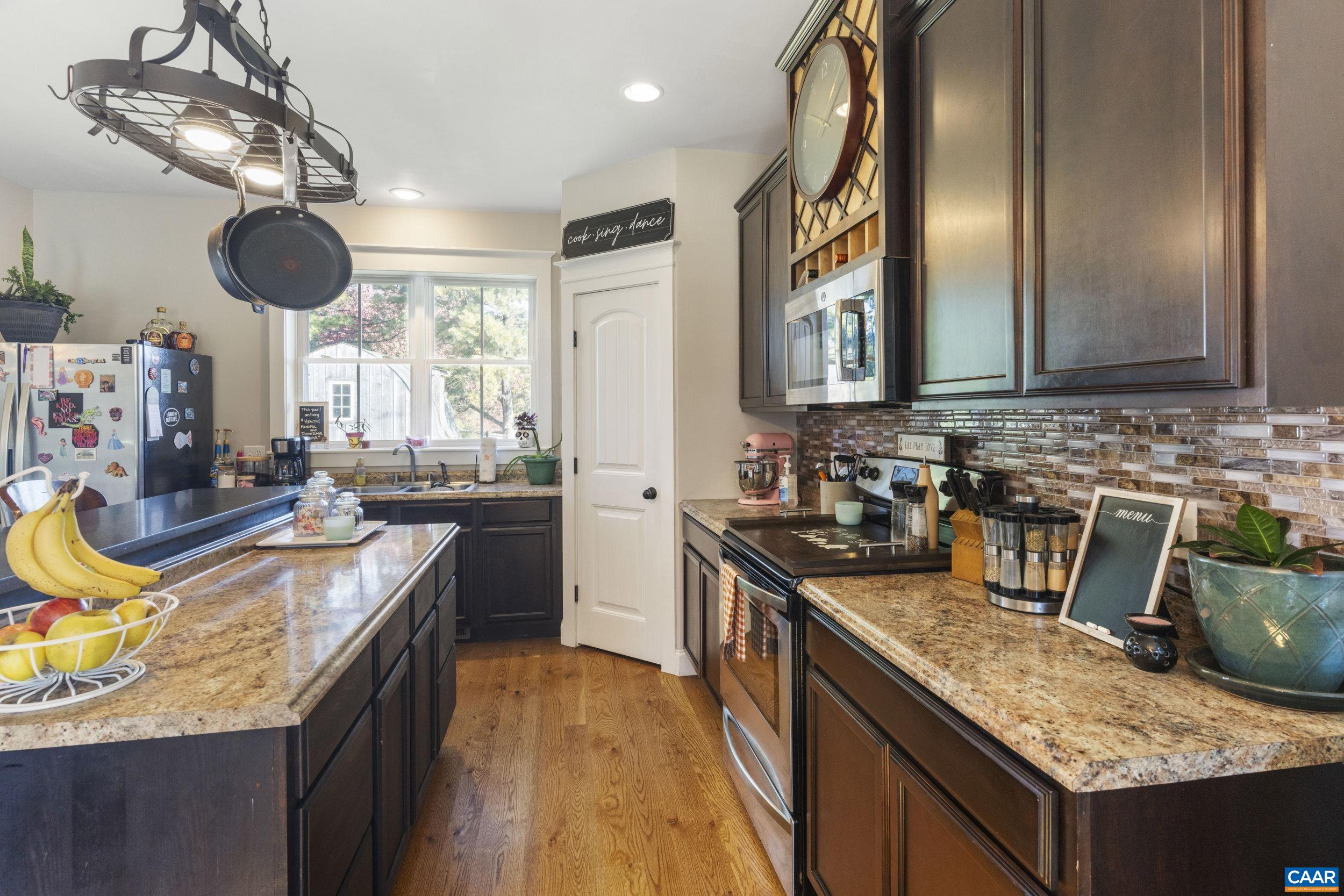 379 Crestview Drive Rustburg, VA 24588 - Photo 9 of 53 a kitchen with kitchen island granite countertop a sink a counter space appliances and cabinets