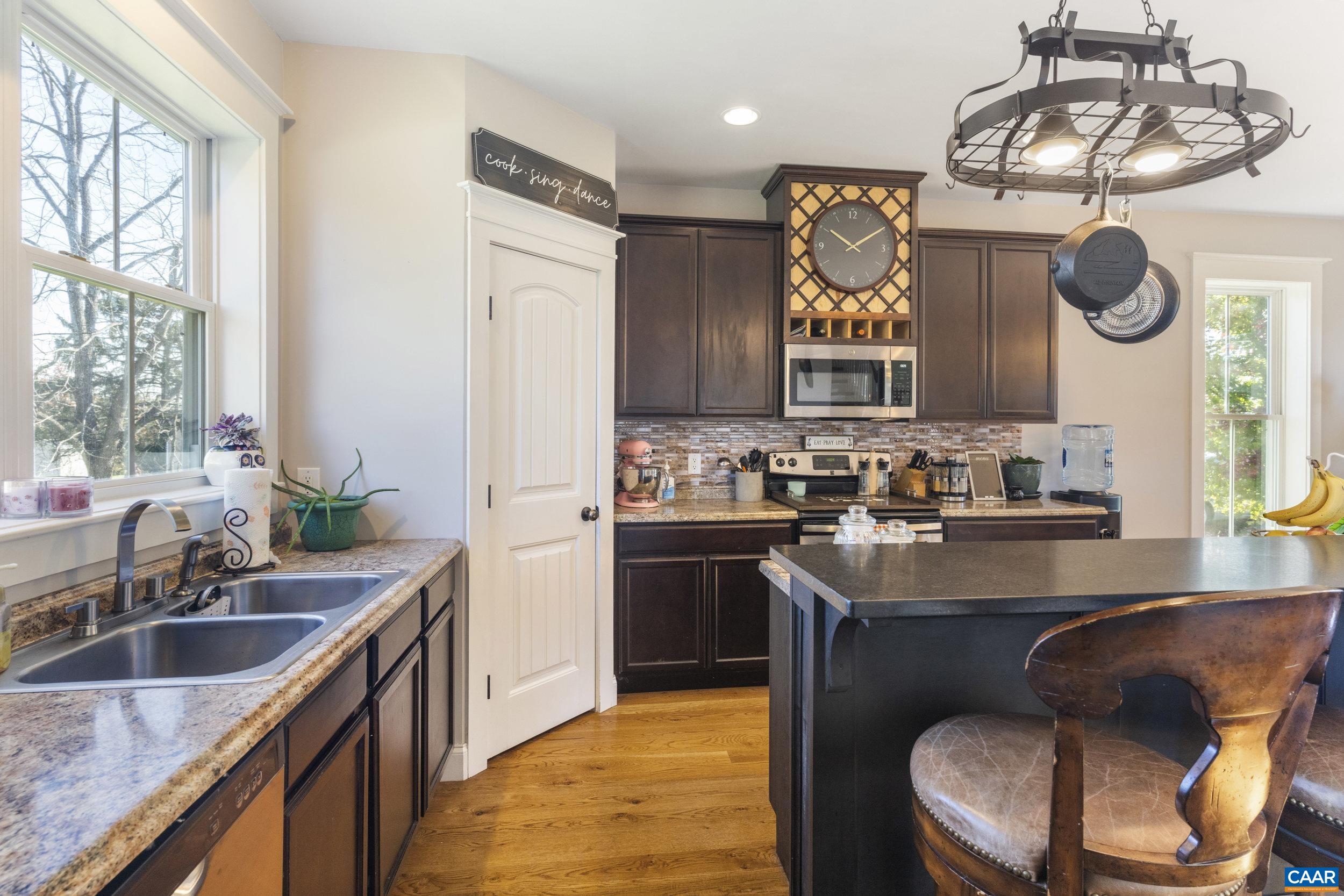 379 Crestview Drive Rustburg, VA 24588 - Photo 10 of 53 a kitchen with stainless steel appliances granite countertop a sink a stove a refrigerator cabinets and a window