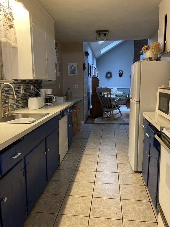 347 Main Street Boxford, MA 01921 - Photo 6 of 13 a kitchen with a sink stove and cabinets