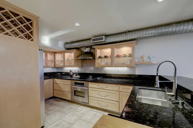 a kitchen with stainless steel appliances granite countertop a stove and a sink