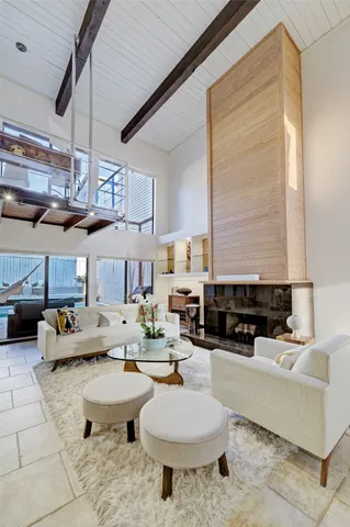 a living room with patio furniture and a fireplace