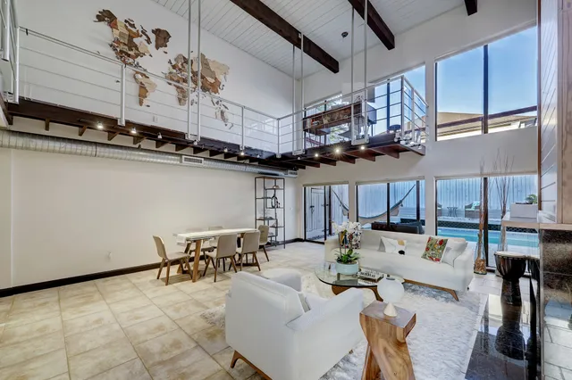 a living room with lots of furniture and kitchen view